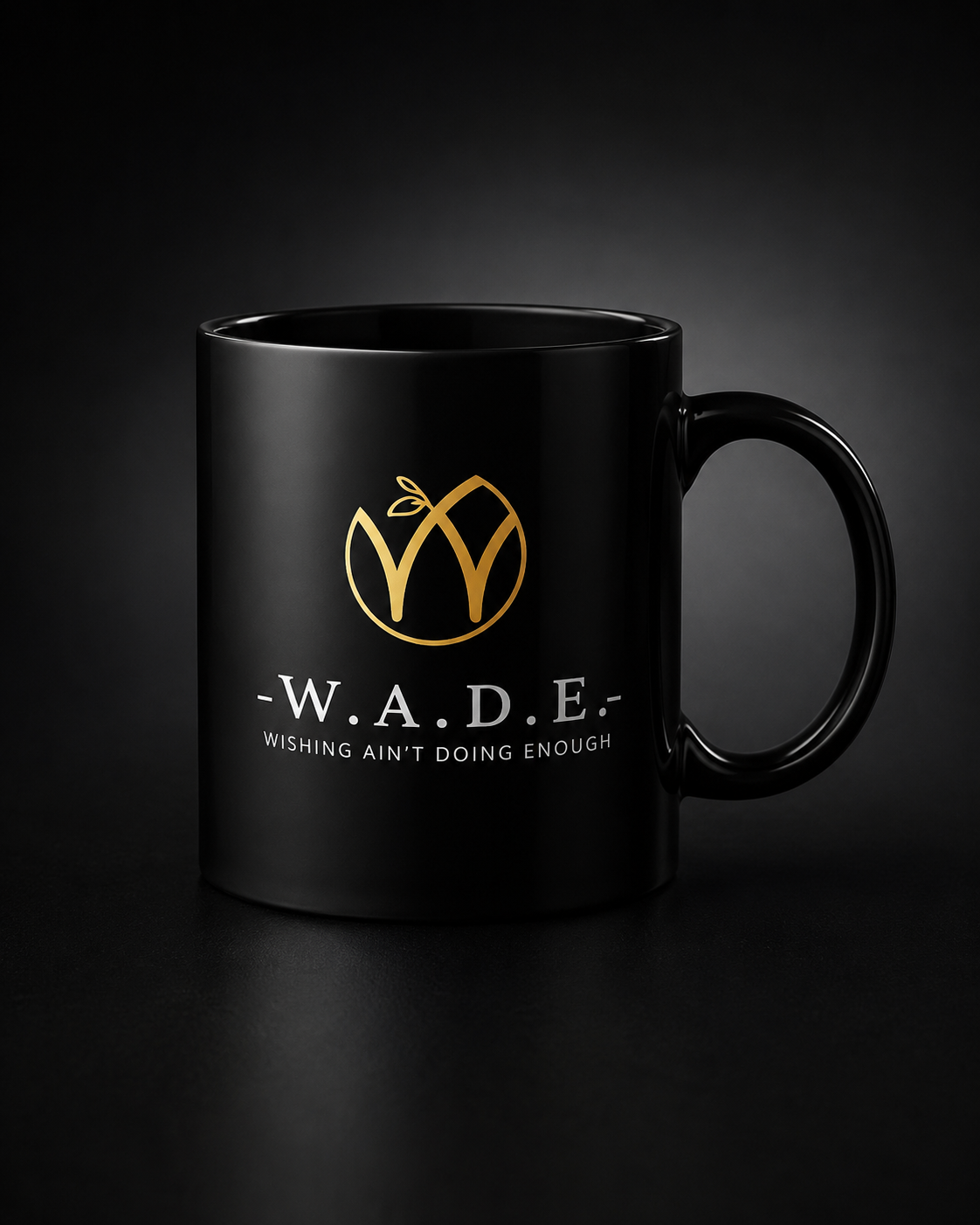 Black ceramic mug with the gold mark and the W.A.D.E. wordmark. Dishwasher and microwave safe. The first cup of the day.